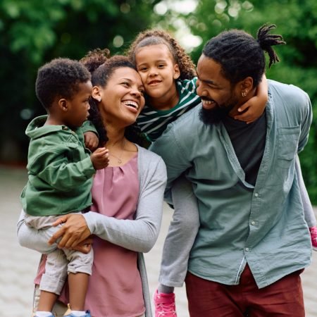 Loving black family enjoys in their time together outdoors.
